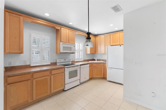 kitchen with pendant lighting, white appliances, light tile patterned floors, and sink