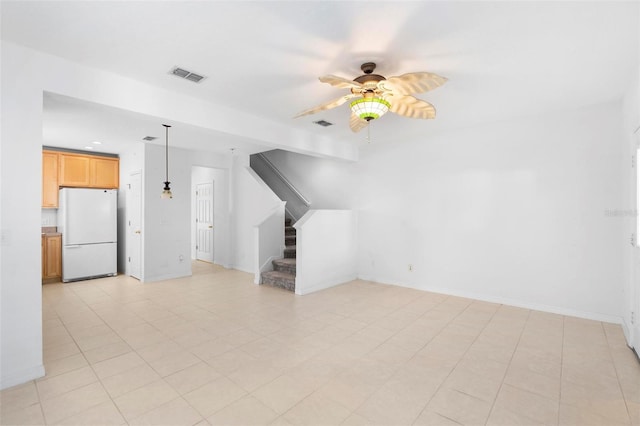 unfurnished living room with light tile patterned floors and ceiling fan