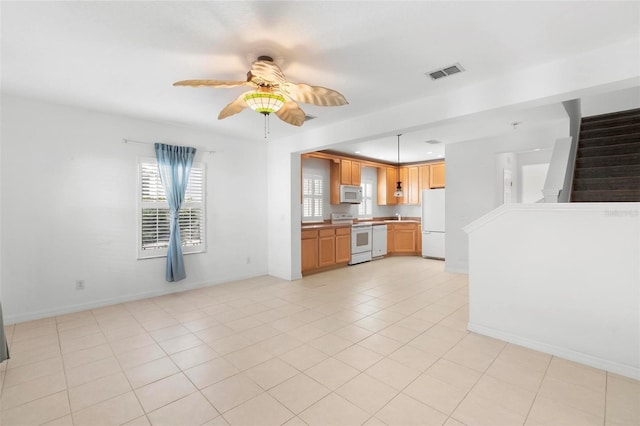 kitchen featuring white appliances, decorative light fixtures, ceiling fan, and light tile patterned flooring