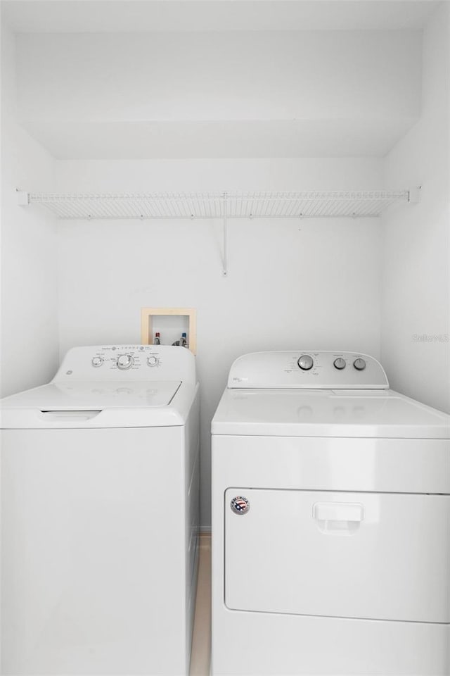 laundry area with washing machine and clothes dryer