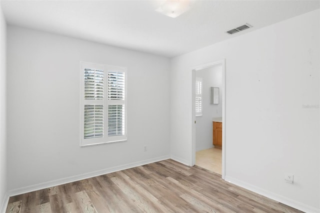 unfurnished room with light hardwood / wood-style flooring