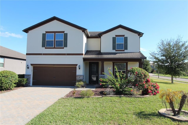 684 Bishop Bay Loop, Apopka, FL 32712 - view of front of home with a garage, a front yard, decorative driveway, stucco siding, and stone siding