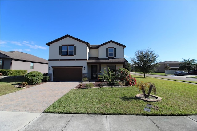 view of property featuring a front yard and a garage