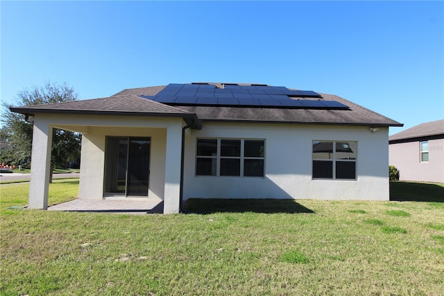 684 Bishop Bay Loop, Apopka, FL 32712 - rear view of property featuring solar panels, a lawn, and stucco siding