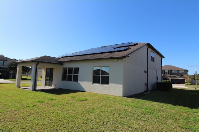 684 Bishop Bay Loop, Apopka, FL 32712 - rear view of property featuring solar panels, a lawn, and stucco siding