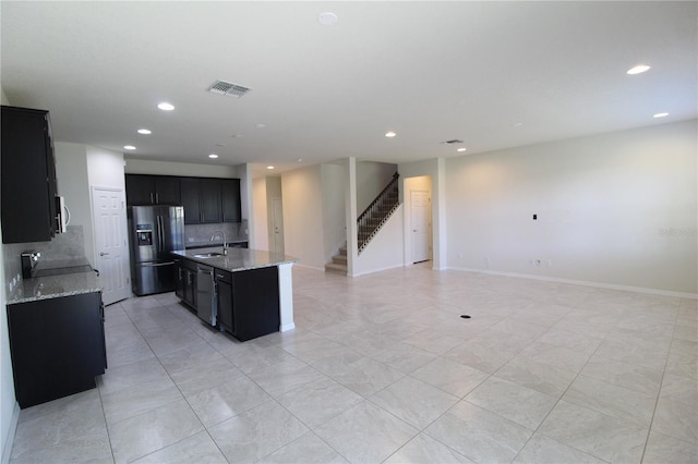 684 Bishop Bay Loop, Apopka, FL 32712 - kitchen featuring stainless steel appliances, dark cabinets, open floor plan, tasteful backsplash, and recessed lighting