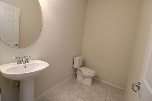 bathroom featuring tile patterned floors, toilet, and sink