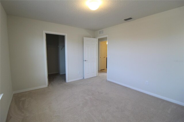 684 Bishop Bay Loop, Apopka, FL 32712 - unfurnished bedroom with light carpet, a spacious closet, and a closet