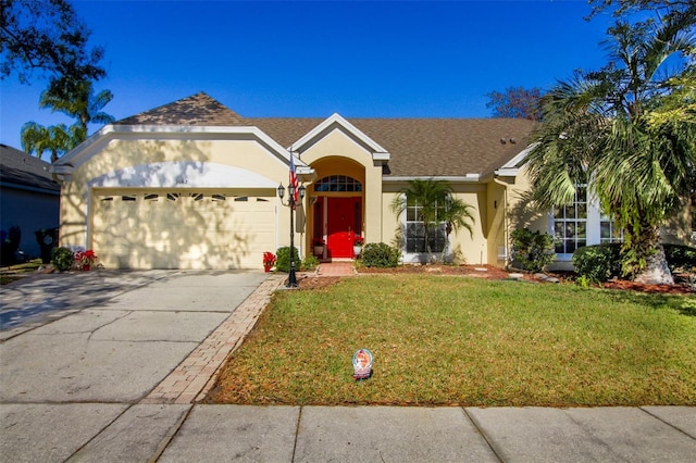 ranch-style house featuring a front lawn and a garage