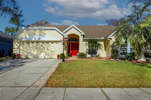 ranch-style house featuring a garage and a front yard