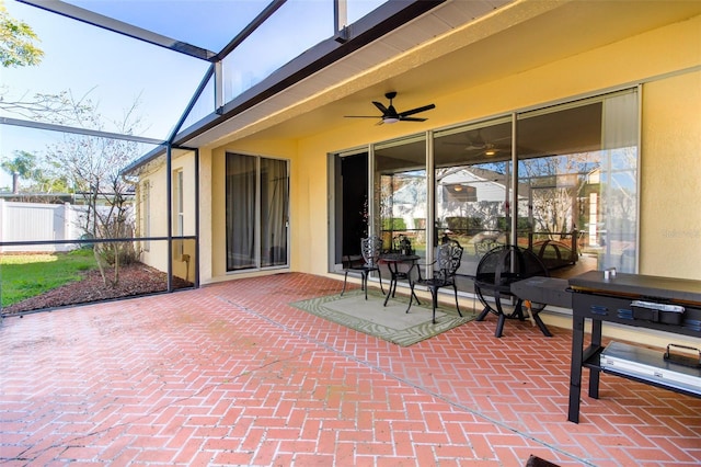 view of patio featuring glass enclosure and ceiling fan