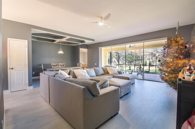 living room featuring ceiling fan and light wood-type flooring