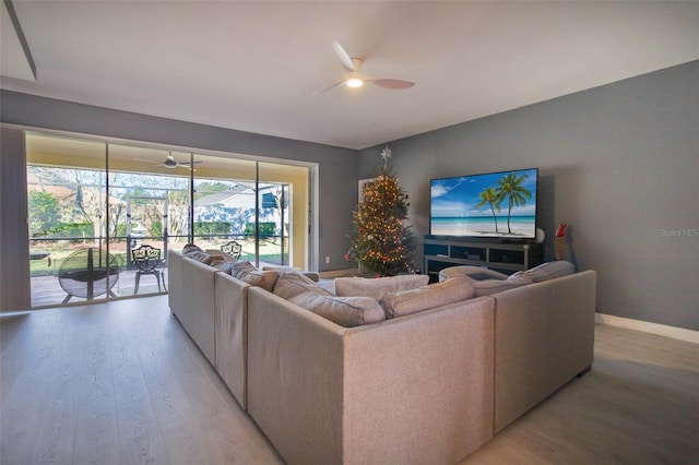 living room featuring light wood-type flooring and ceiling fan