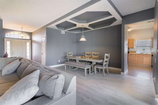 living room with sink and light hardwood / wood-style floors