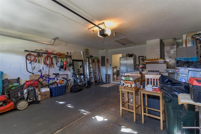 garage with electric panel, washer / clothes dryer, and a garage door opener