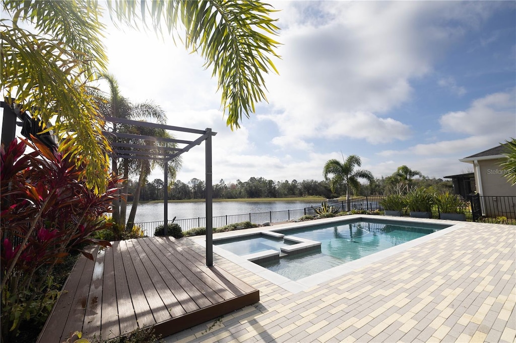 view of swimming pool featuring an in ground hot tub, a water view, a patio, and a pergola