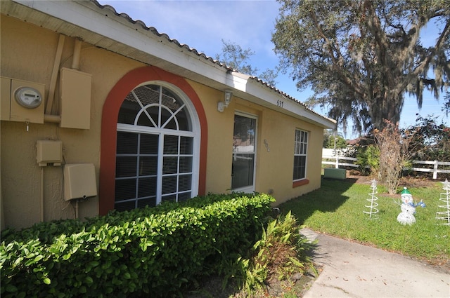 view of side of home with a lawn