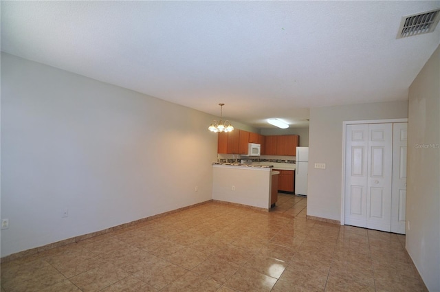 kitchen featuring white appliances, backsplash, hanging light fixtures, kitchen peninsula, and a chandelier