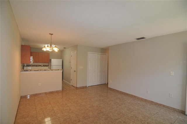 unfurnished living room with a notable chandelier