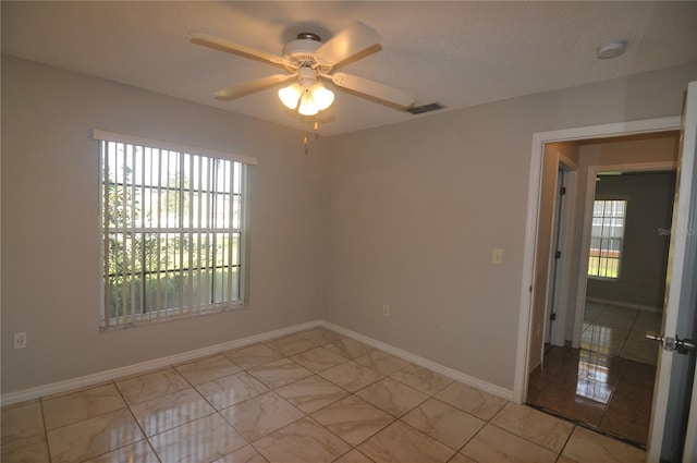 unfurnished room featuring ceiling fan