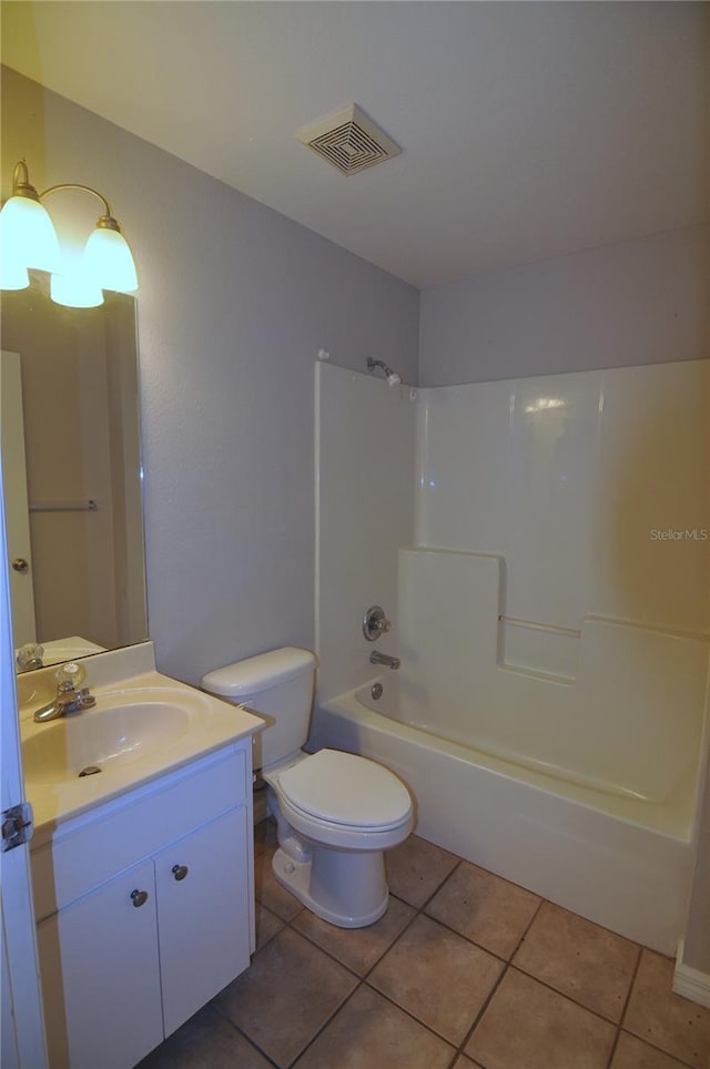 full bathroom with bathing tub / shower combination, tile patterned flooring, vanity, and toilet