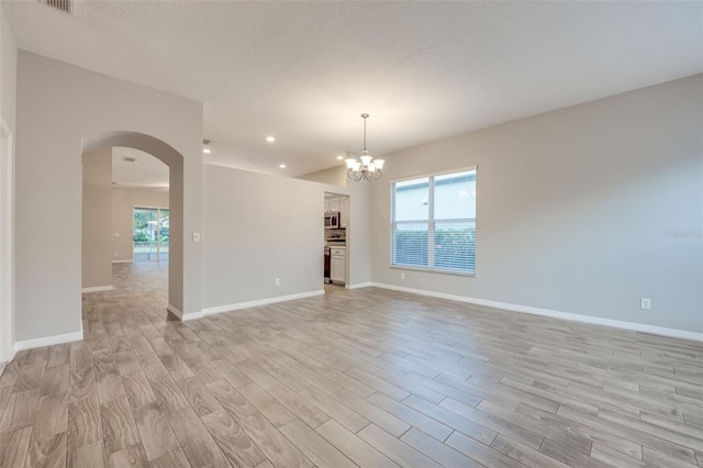 interior space with a chandelier, light hardwood / wood-style floors, and a healthy amount of sunlight