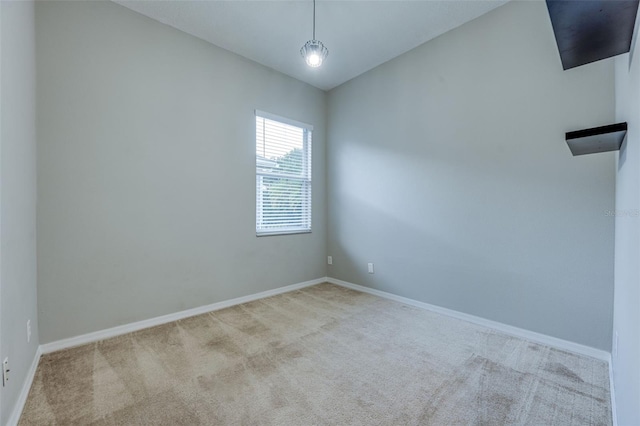 unfurnished room featuring light colored carpet