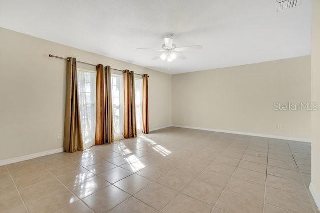 empty room featuring ceiling fan and light tile patterned floors