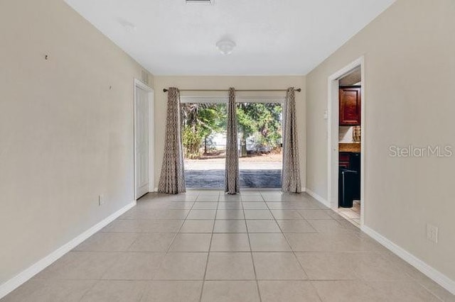 spare room with light tile patterned floors