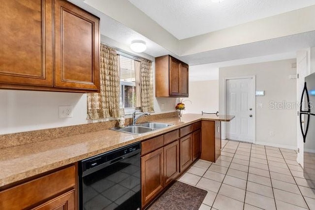 kitchen featuring light stone countertops, sink, black dishwasher, fridge, and light tile patterned floors