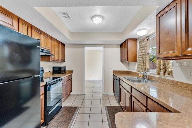 kitchen with light tile patterned flooring, a textured ceiling, sink, and black appliances