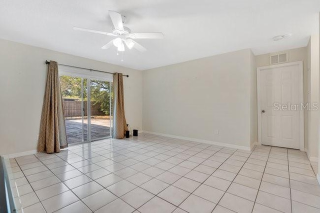 unfurnished room featuring light tile patterned floors and ceiling fan