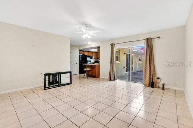 spare room featuring ceiling fan and light tile patterned floors
