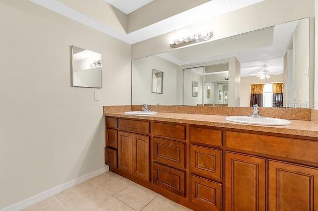 bathroom featuring tile patterned flooring, ceiling fan, and vanity