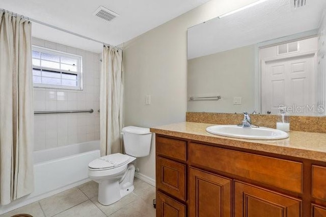 full bathroom with tile patterned flooring, vanity, shower / bath combo, and toilet