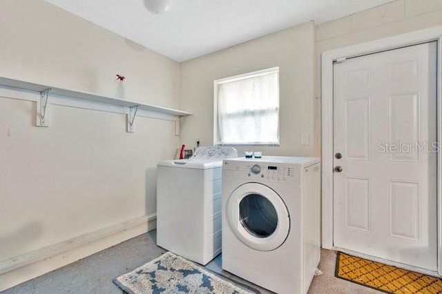 washroom with washing machine and clothes dryer
