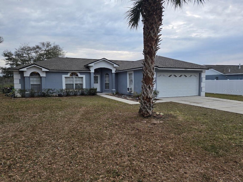 ranch-style house with a front lawn and a garage