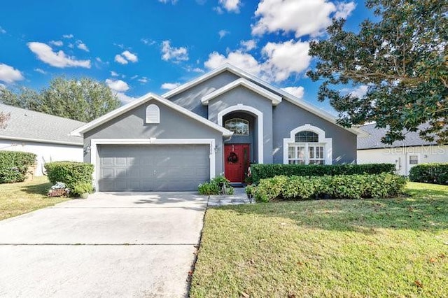 single story home with concrete driveway, a garage, a front yard, and stucco siding