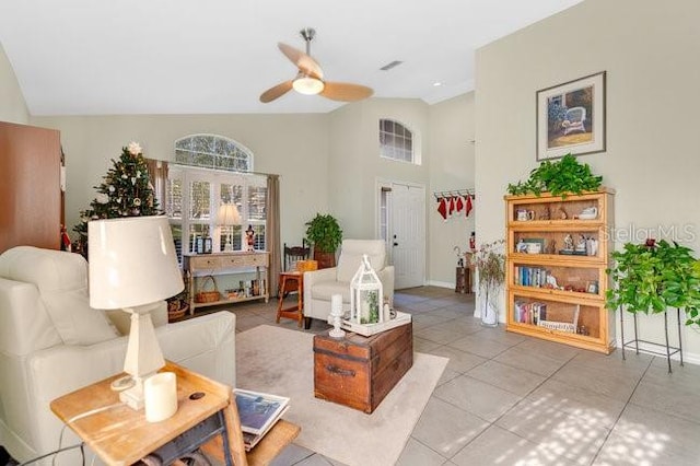 tiled living room featuring ceiling fan and vaulted ceiling