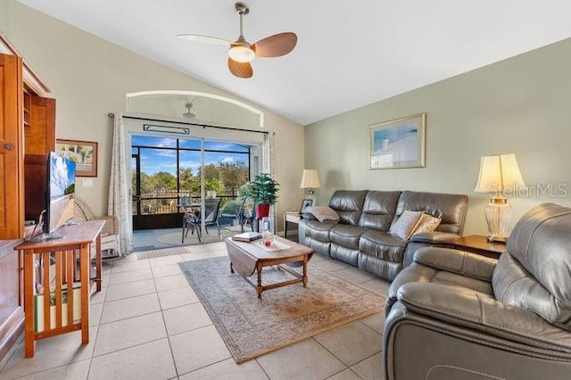 living room featuring vaulted ceiling, ceiling fan, and light tile patterned floors