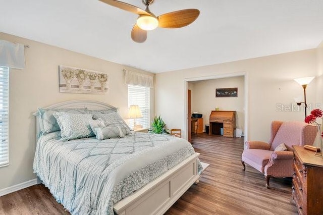 bedroom featuring ceiling fan and dark hardwood / wood-style floors