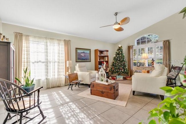 interior space featuring light tile patterned flooring, lofted ceiling, and ceiling fan