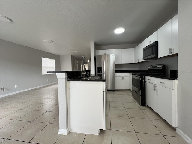 kitchen with white cabinets, a kitchen breakfast bar, black electric range, stainless steel fridge, and light tile patterned floors