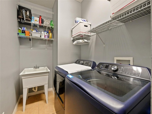 laundry room featuring tile patterned floors and washer and clothes dryer