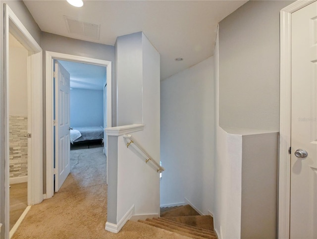 stairs featuring carpet flooring