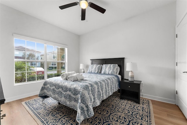 bedroom with ceiling fan and wood-type flooring