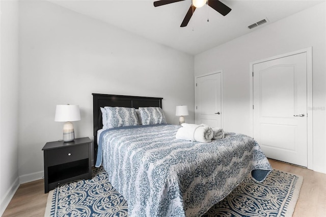 bedroom with ceiling fan and light hardwood / wood-style floors