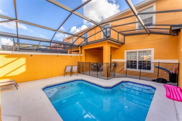 view of pool with glass enclosure and a patio area