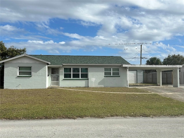 single story home featuring a front yard and a carport