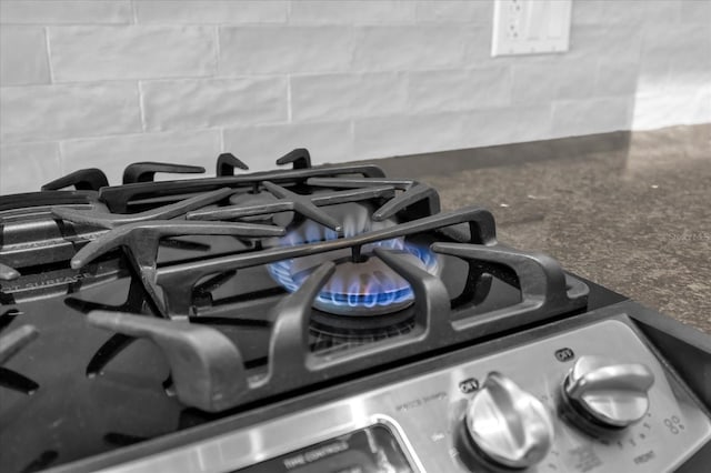 room details featuring stainless steel stove and backsplash